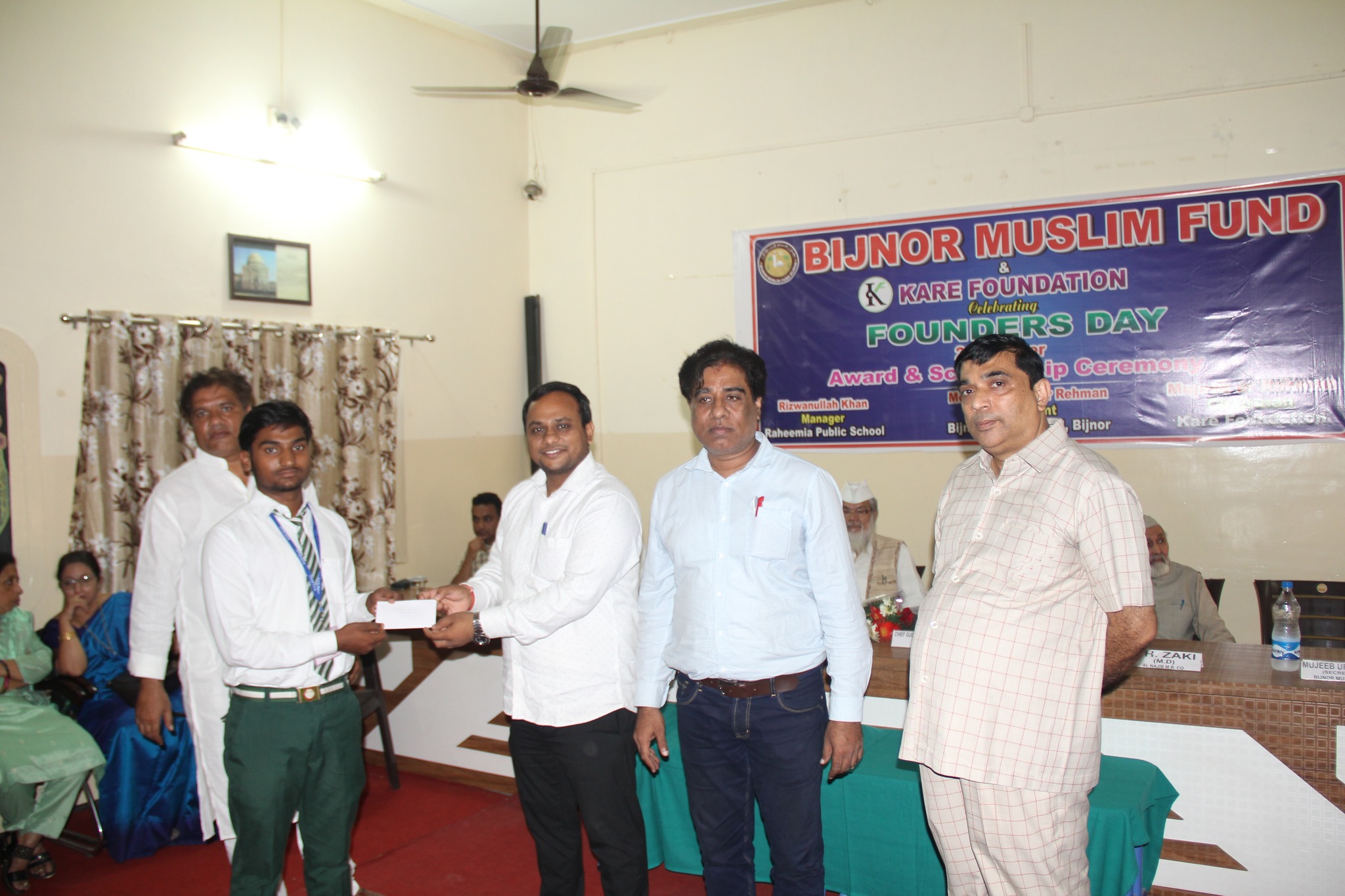 Previous year Founder's Day - Scholarship check presentation to young student