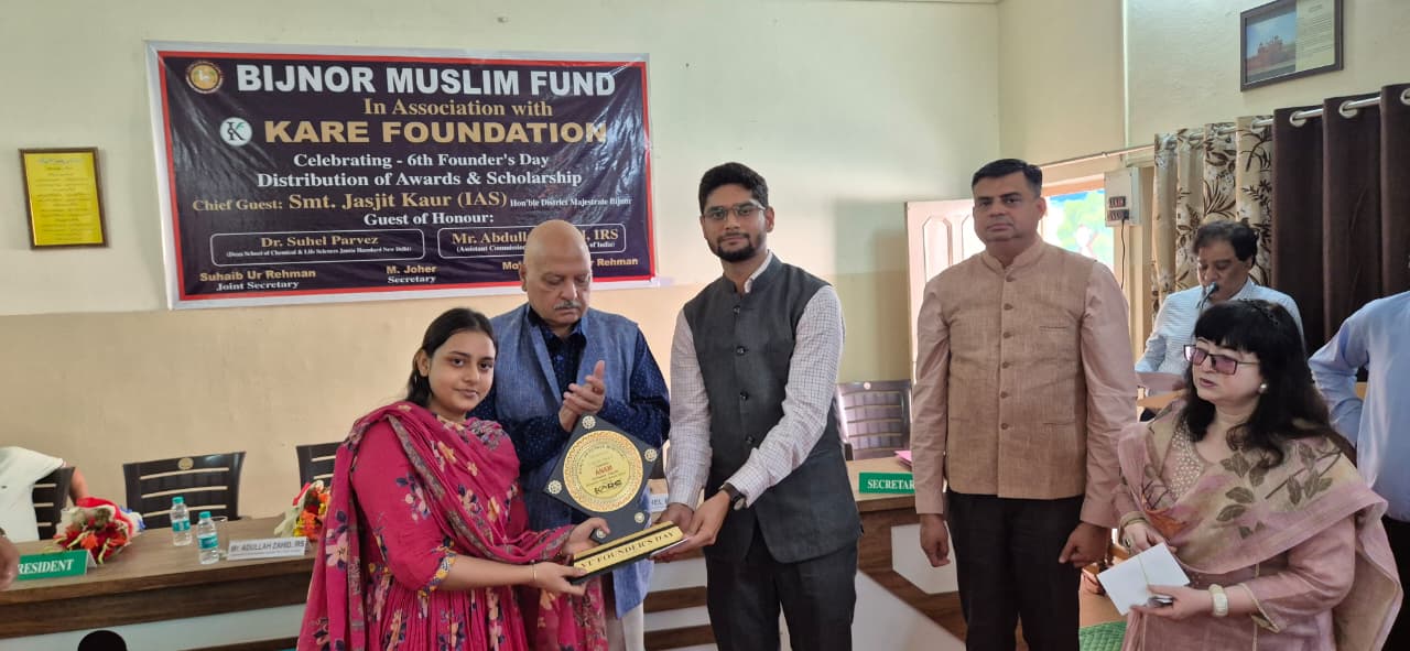 Female student receiving scholarship award during 6th Founder's Day celebration - 2025