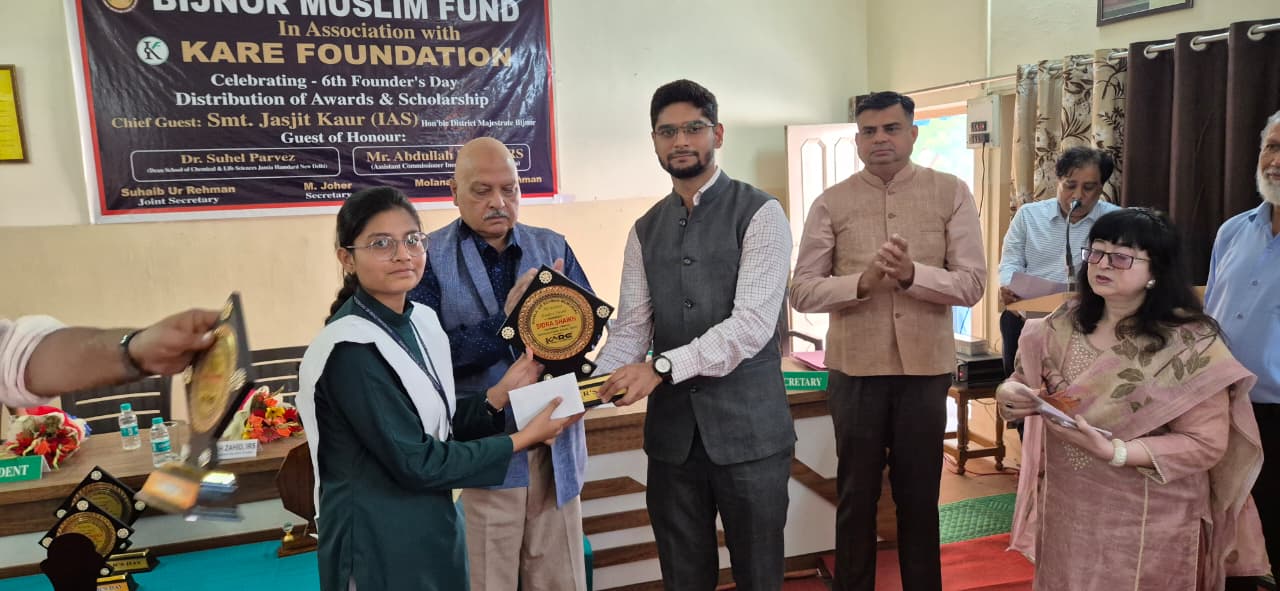 Student scholar receiving award trophy at scholarship distribution ceremony - 2025